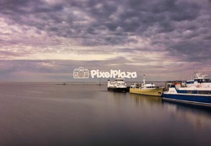 Ships at the Tallinn City Hall pier in the evening